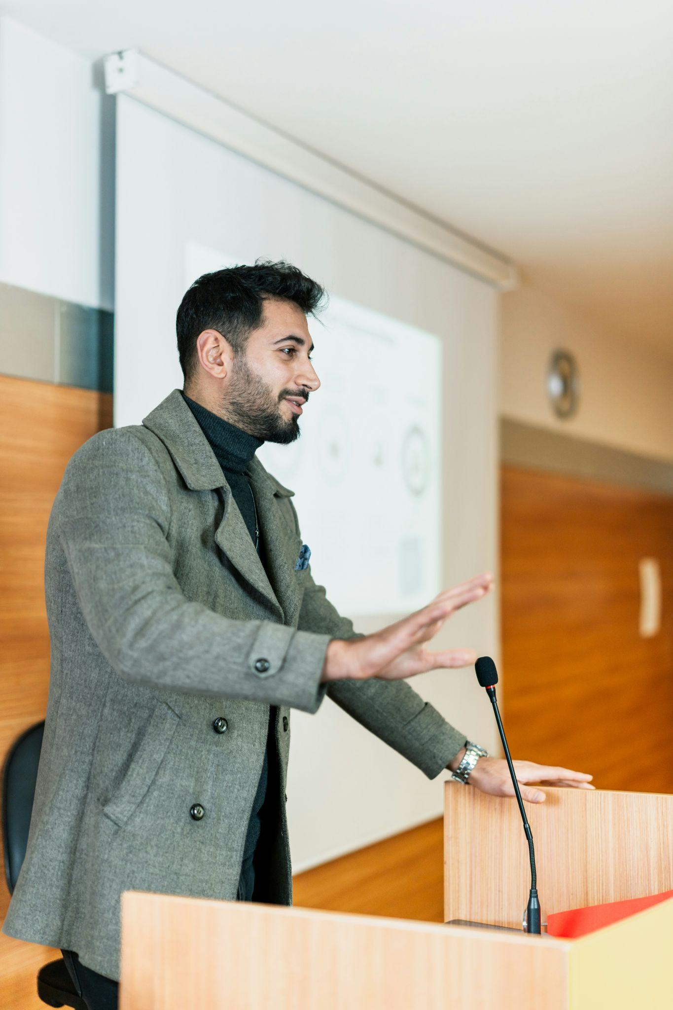 Speaker presenting confidently at a lectern